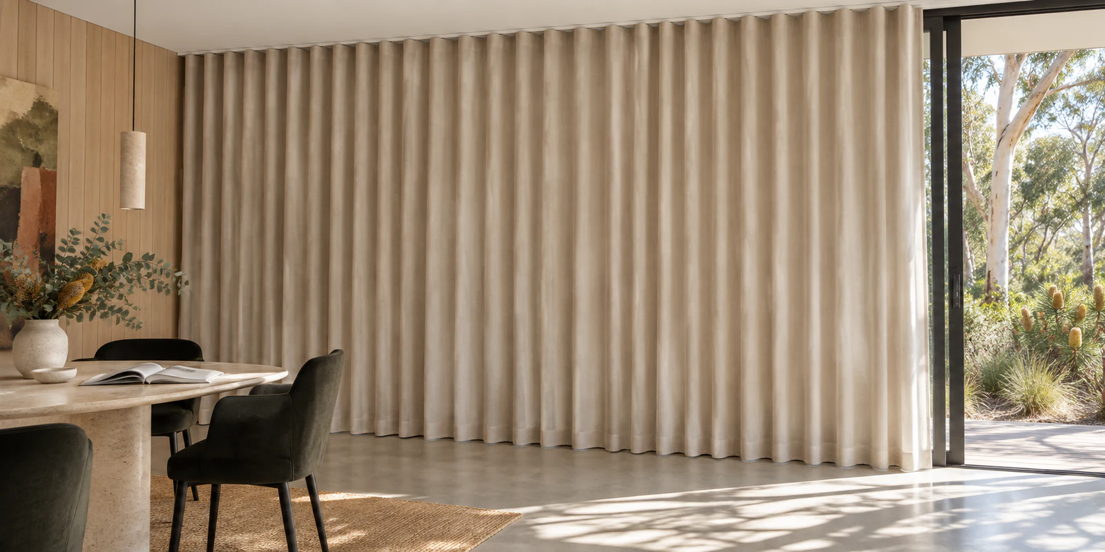 Full-height ivory S-fold wave curtains hanging in continuous unpinched waves from a visible ceiling-line track.