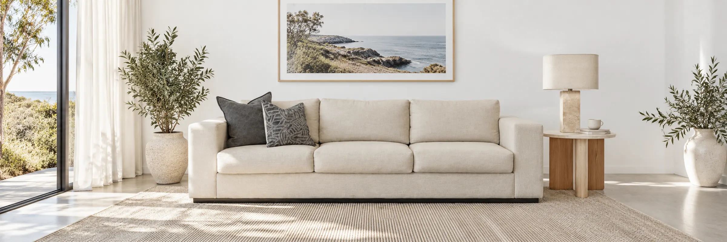 Ava Travertine Table Lamp styled in a furnished white coastal home